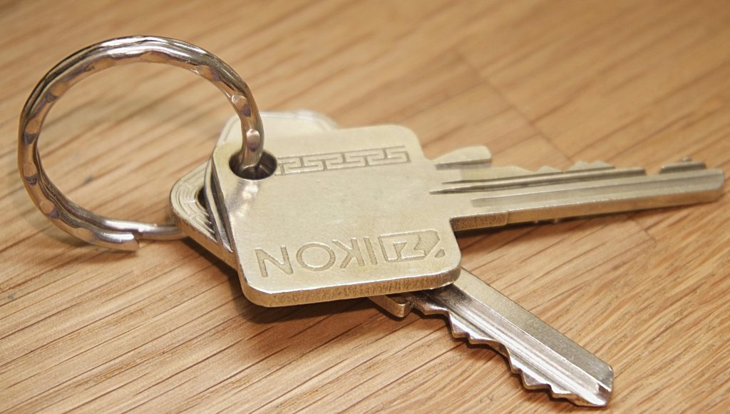 Keys on a key ring laying on a wooden table