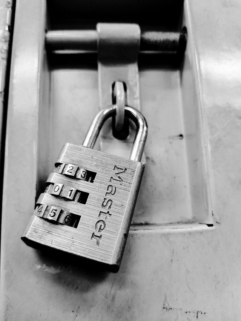 Master lock with combination locked on door